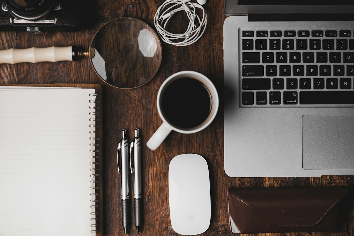Workspace with laptop, notebook and coffee