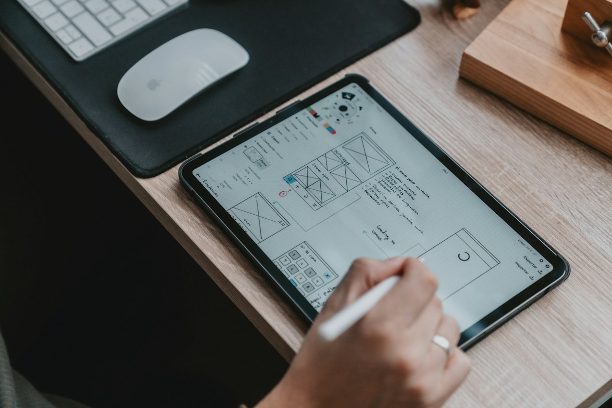 Designer sketching a slide layout on a tablet